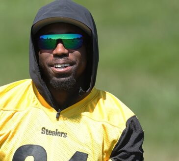 Pittsburgh Steelers cornerback Joey Porter Jr. smiles in sunglasses and a hood while watching practice.