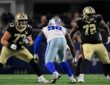 Dallas Cowboys defensive tackle Jonathan Bullard squares up between two New Orleans Saints offensive tackles in pass protection.
