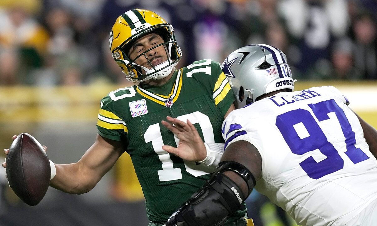 Dallas Cowboys defensive tackle Kenny Clark hits Green Bay Packers quarterback Jordan Love as he tries to throw.