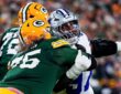 Dallas Cowboys defensive tackle Kenny Clark extends an arm as he battles past a Green Bay Packers lineman.