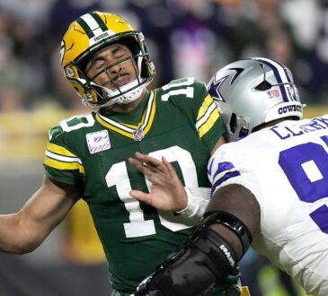 Dallas Cowboys defensive tackle Kenny Clark hits Green Bay Packers quarterback Jordan Love as he tries to throw.