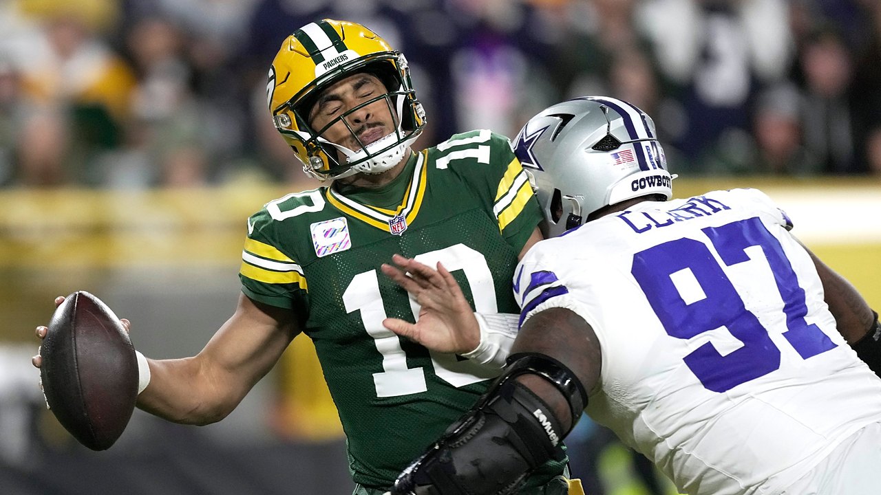 Dallas Cowboys defensive tackle Kenny Clark hits Green Bay Packers quarterback Jordan Love as he tries to throw.