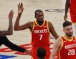 Rockets forward Kevin Durant raises his hand for a high-five from a teammate as they walk off the court.