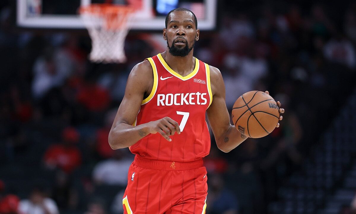 Houston Rockets forward Kevin Durant dribbles the ball with his left hand while bringing it up the court.