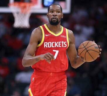 Houston Rockets forward Kevin Durant dribbles the ball with his left hand while bringing it up the court.