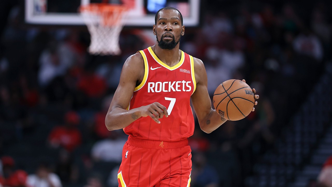 Houston Rockets forward Kevin Durant dribbles the ball with his left hand while bringing it up the court.