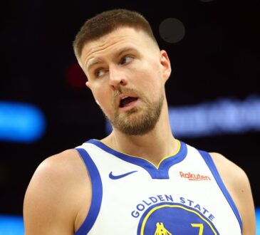 Golden State Warriors center Kristaps Porzingis on the court against the Phoenix Suns during the 2026 NBA play-in tournament at Mortgage Matchup Center in Phoenix.