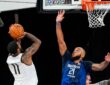 Mavericks guard Kyrie Irving rises for a jump shot as forward Daniel Gafford stretches to contest it at practice.