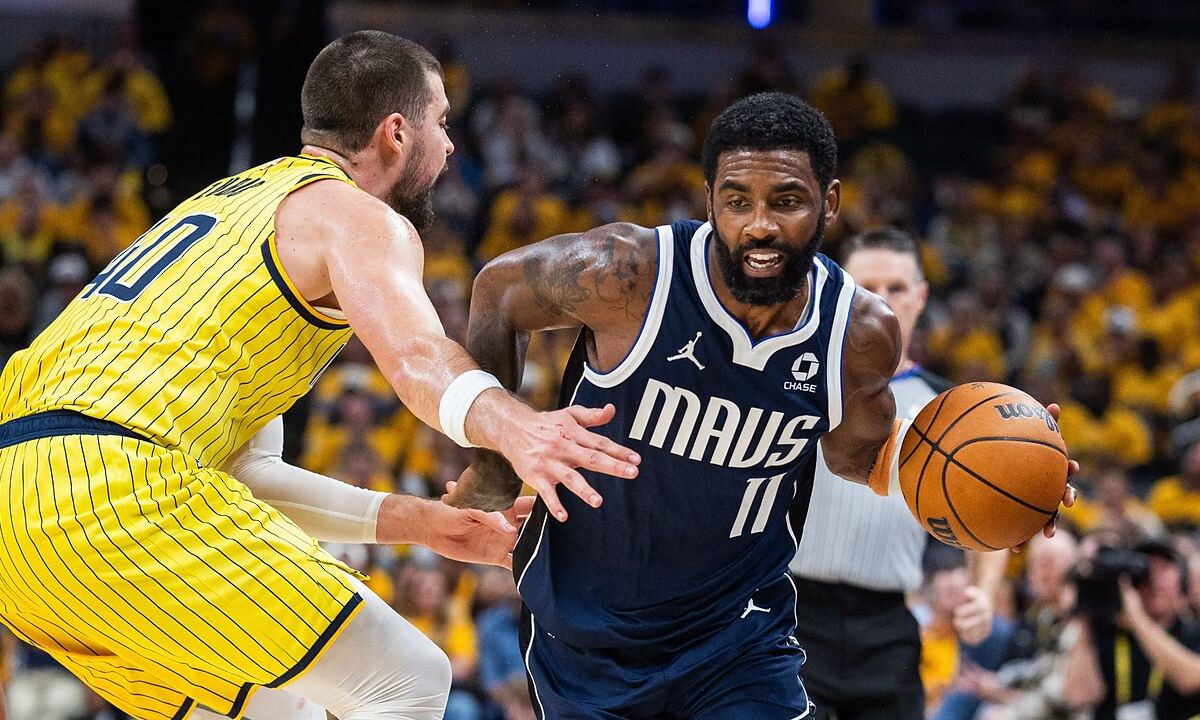 Dallas Mavericks guard Kyrie Irving drives with the ball as Indiana Pacers center Ivica Zubac reaches in to defend.