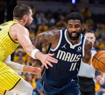 Dallas Mavericks guard Kyrie Irving drives with the ball as Indiana Pacers center Ivica Zubac reaches in to defend.