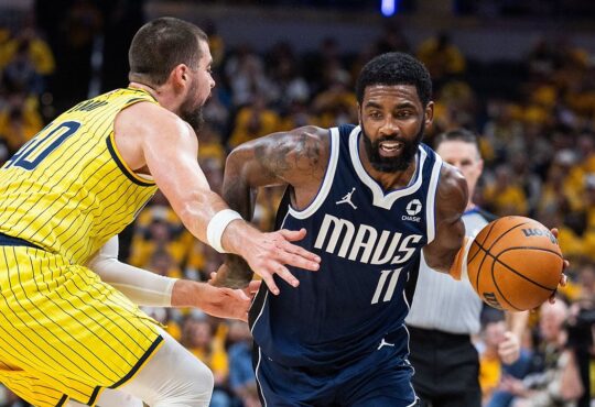 Dallas Mavericks guard Kyrie Irving drives with the ball as Indiana Pacers center Ivica Zubac reaches in to defend.