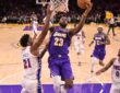 Los Angeles Lakers forward LeBron James #23 drives past Philadelphia 76ers center Joel Embiid #21 at Crypto.com Arena.
