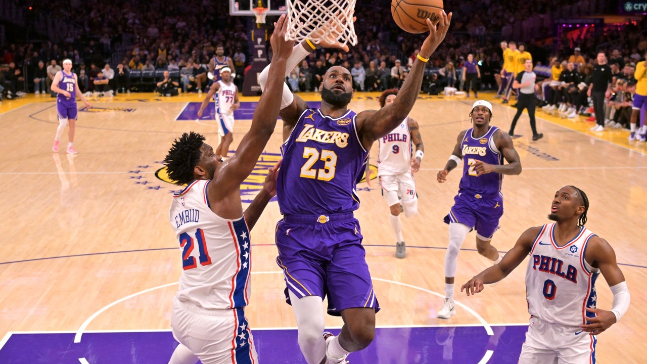 Los Angeles Lakers forward LeBron James #23 drives past Philadelphia 76ers center Joel Embiid #21 at Crypto.com Arena.