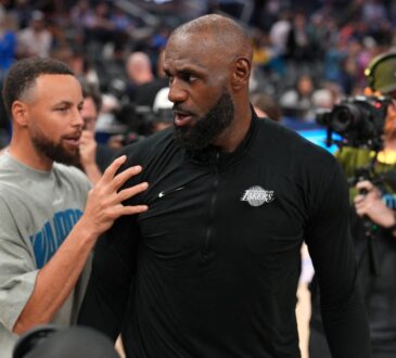 Los Angeles Lakers forward LeBron James #23 meets with Golden State Warriors guard Stephen Curry #30 after a game at Chase Center.