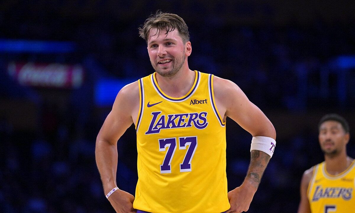 Los Angeles Lakers guard Luka Dončić #77 smiles at the free throw line against the Sacramento Kings at Crypto.com Arena.