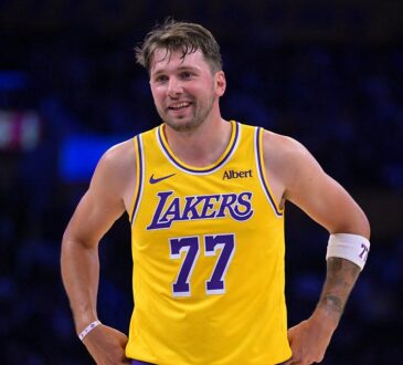 Los Angeles Lakers guard Luka Dončić #77 smiles at the free throw line against the Sacramento Kings at Crypto.com Arena.