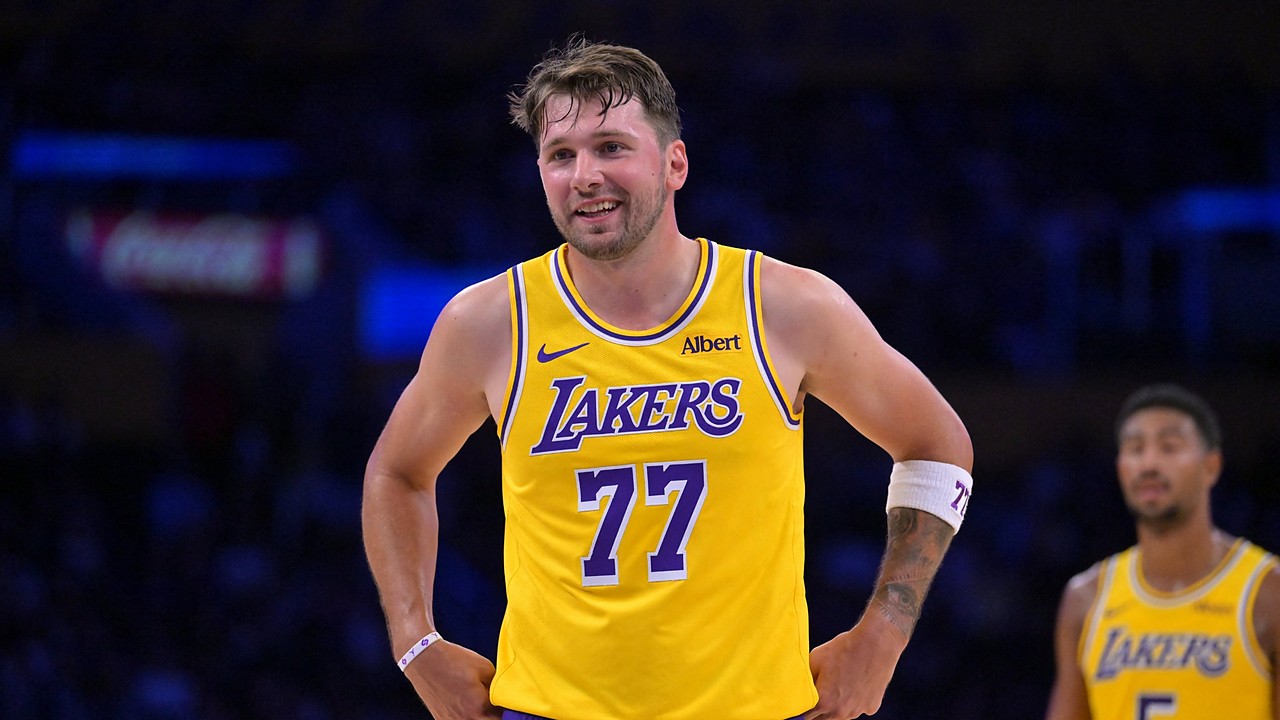 Los Angeles Lakers guard Luka Dončić #77 smiles at the free throw line against the Sacramento Kings at Crypto.com Arena.