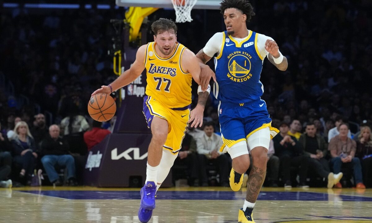 Los Angeles Lakers guard Luka Doncic #77 drives to the basket against Golden State Warriors forward Yaxel Lendeborg #1 at Crypto.com Arena.