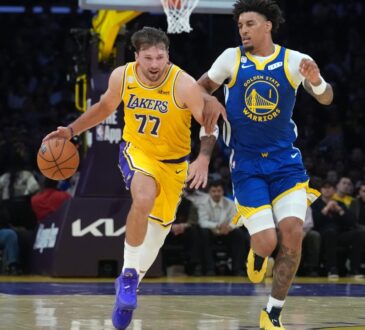Los Angeles Lakers guard Luka Doncic #77 drives to the basket against Golden State Warriors forward Yaxel Lendeborg #1 at Crypto.com Arena.