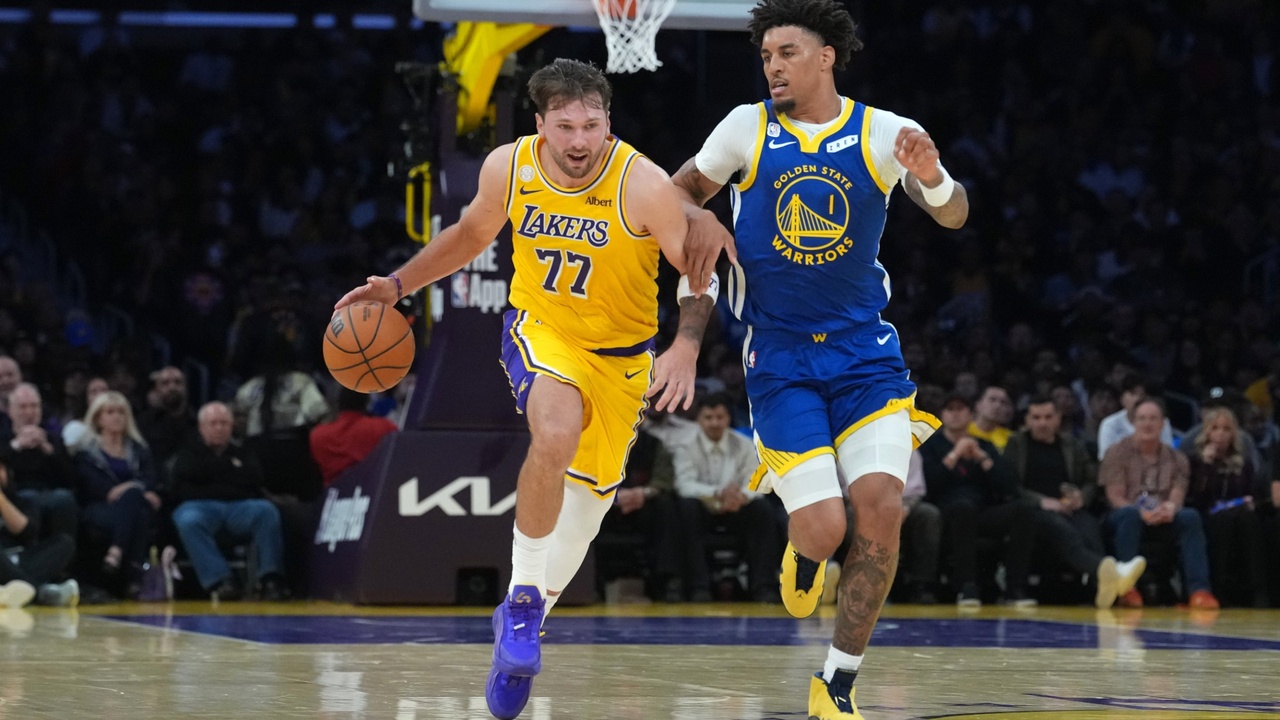 Los Angeles Lakers guard Luka Doncic #77 drives to the basket against Golden State Warriors forward Yaxel Lendeborg #1 at Crypto.com Arena.