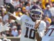 Texas A&M quarterback Marcel Reed cocks his arm back to throw as a defender's gloved hand reaches in from the left.
