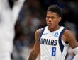 Dallas Mavericks guard Marcus Sasser stares ahead with his hands on his hips during a stoppage in play.
