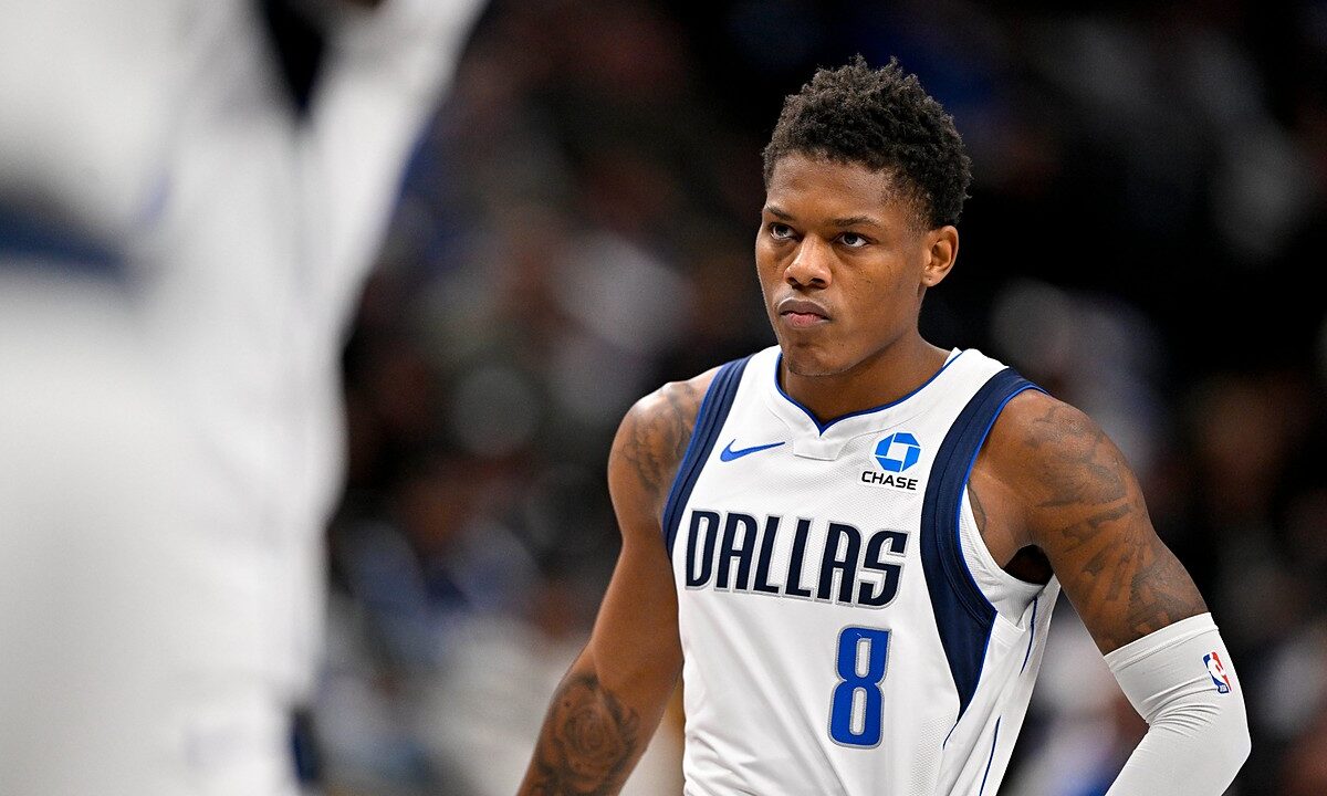 Dallas Mavericks guard Marcus Sasser stares ahead with his hands on his hips during a stoppage in play.