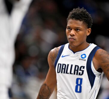 Dallas Mavericks guard Marcus Sasser stares ahead with his hands on his hips during a stoppage in play.
