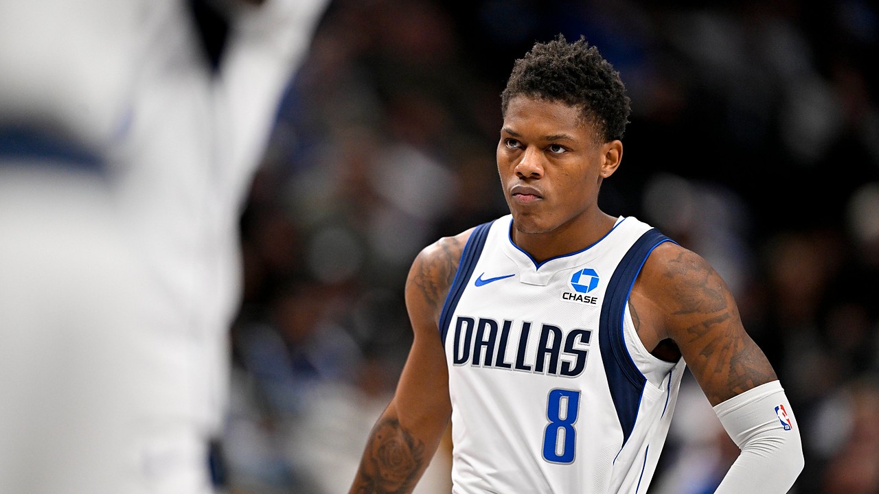 Dallas Mavericks guard Marcus Sasser stares ahead with his hands on his hips during a stoppage in play.