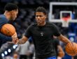 Dallas Mavericks guard Marcus Sasser dribbles during warmups in a black Mavericks T-shirt as a staff member works with him.