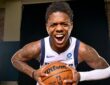 Dallas Mavericks guard Marcus Sasser yells and leans toward the camera while gripping a basketball with both hands.