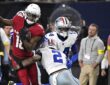 Arizona Cardinals wide receiver Marvin Harrison Jr. carries the ball as Dallas Cowboys safety Juanyeh Thomas reaches to tackle.
