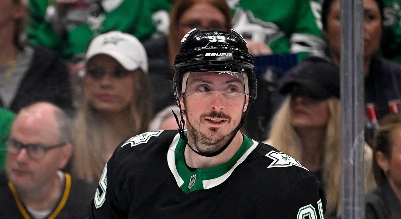Stars center Matt Duchene, in the team's black alternate jersey, glances over his shoulder with fans behind the glass.
