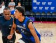 Mavericks guard Max Christie dribbles past a staff member defending him during practice.