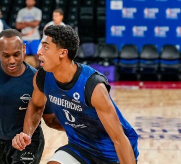 Mavericks guard Max Christie dribbles past a staff member defending him during practice.