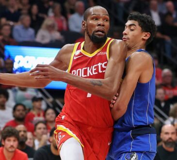 Houston Rockets forward Kevin Durant drives with the ball in his right hand as Dallas Mavericks guard Max Christie defends him.