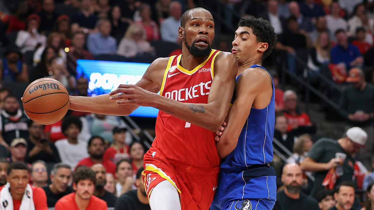 Houston Rockets forward Kevin Durant drives with the ball in his right hand as Dallas Mavericks guard Max Christie defends him.