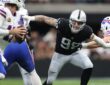 Las Vegas Raiders defensive end Maxx Crosby fights through a block as he closes in on the Buffalo Bills quarterback.