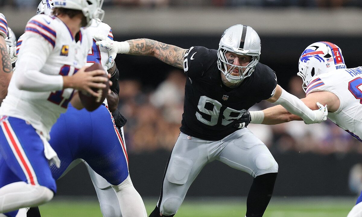 Las Vegas Raiders defensive end Maxx Crosby fights through a block as he closes in on the Buffalo Bills quarterback.