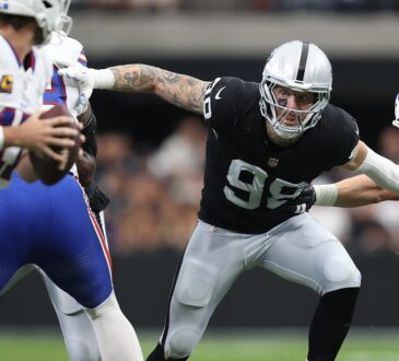 Las Vegas Raiders defensive end Maxx Crosby fights through a block as he closes in on the Buffalo Bills quarterback.