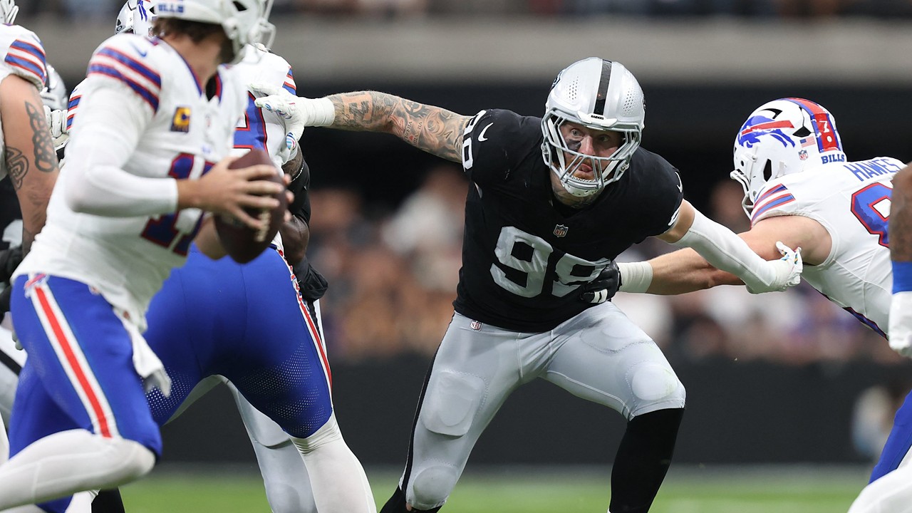 Las Vegas Raiders defensive end Maxx Crosby fights through a block as he closes in on the Buffalo Bills quarterback.
