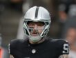 Raiders defensive end Maxx Crosby stands on the field between plays.