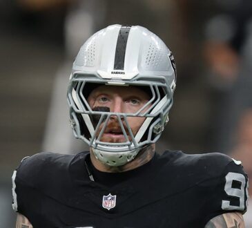 Raiders defensive end Maxx Crosby stands on the field between plays.
