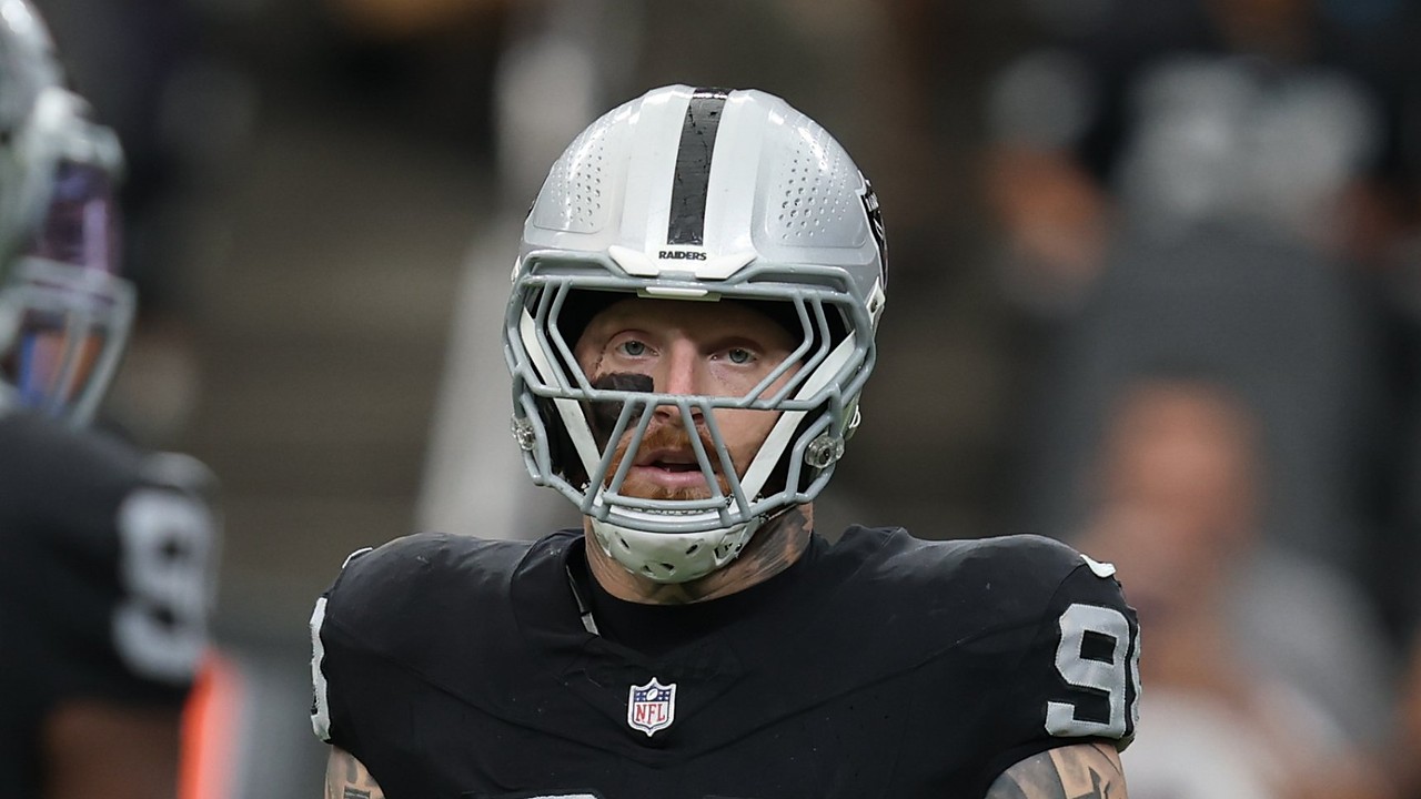 Raiders defensive end Maxx Crosby stands on the field between plays.