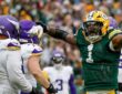 Packers defensive end Micah Parsons yells and points after a sack as Vikings left tackle Christian Darrisaw looks on.