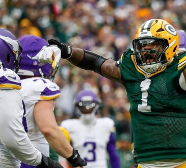 Packers defensive end Micah Parsons yells and points after a sack as Vikings left tackle Christian Darrisaw looks on.