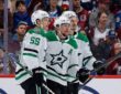 Dallas Stars defenseman Miro Heiskanen celebrates a goal with defenseman Thomas Harley and center Roope Hintz along the boards.