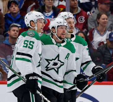 Dallas Stars defenseman Miro Heiskanen celebrates a goal with defenseman Thomas Harley and center Roope Hintz along the boards.