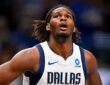 Dallas Mavericks forward Morez Johnson Jr. looks up toward the rim with his hands on his hips during a game.