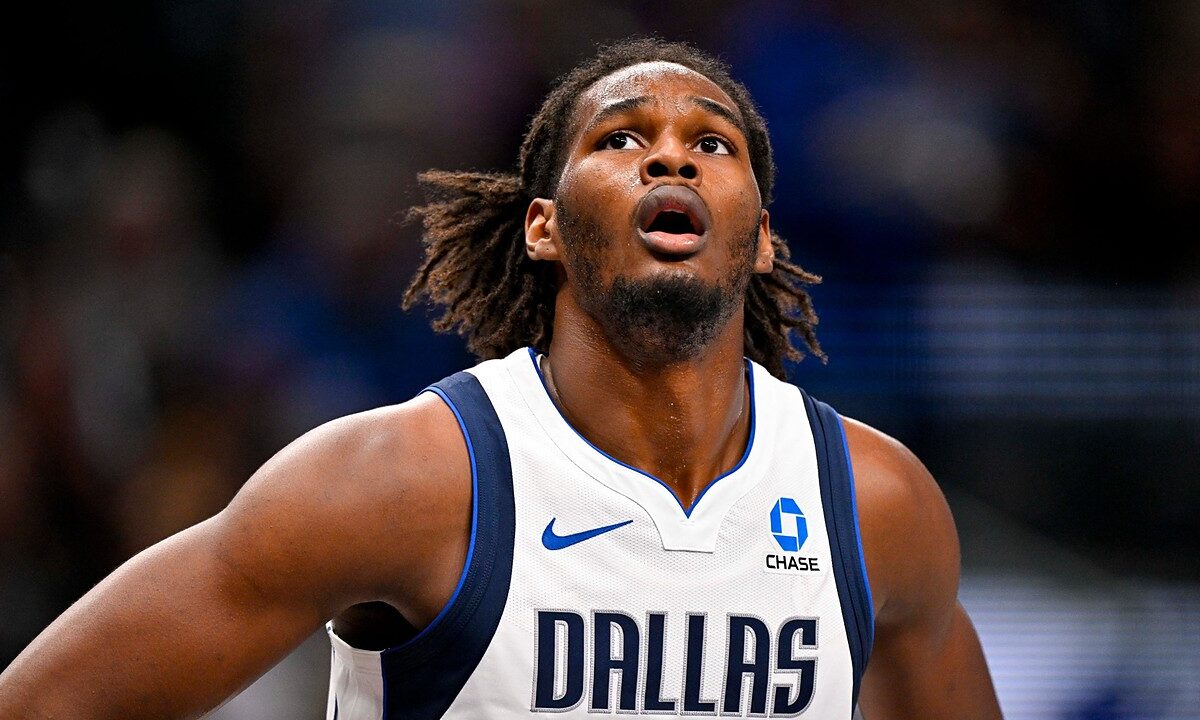 Dallas Mavericks forward Morez Johnson Jr. looks up toward the rim with his hands on his hips during a game.